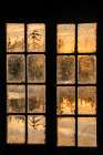 USA, New York Adirondack Park, Saranac Lake, Hoel Pond, sunrise reflection through boathouse window Art Print